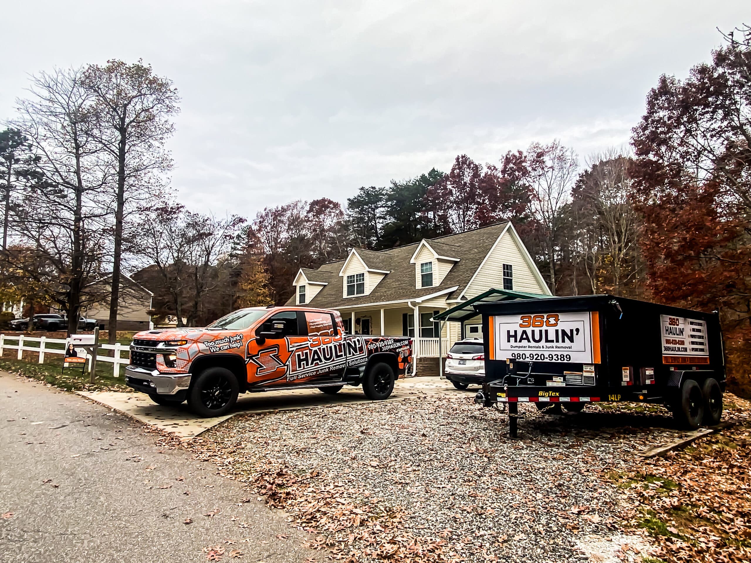 360 Haulin' truck and dumpster trailer on a residential driveway
