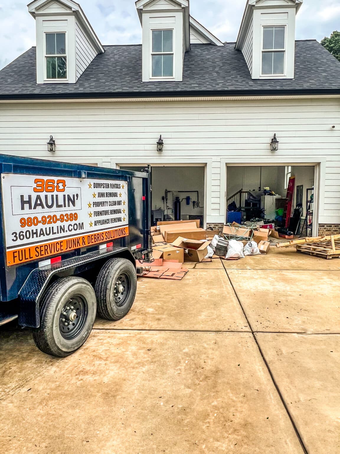 360 Haulin' dumpster trailer staged for a garage cleanout